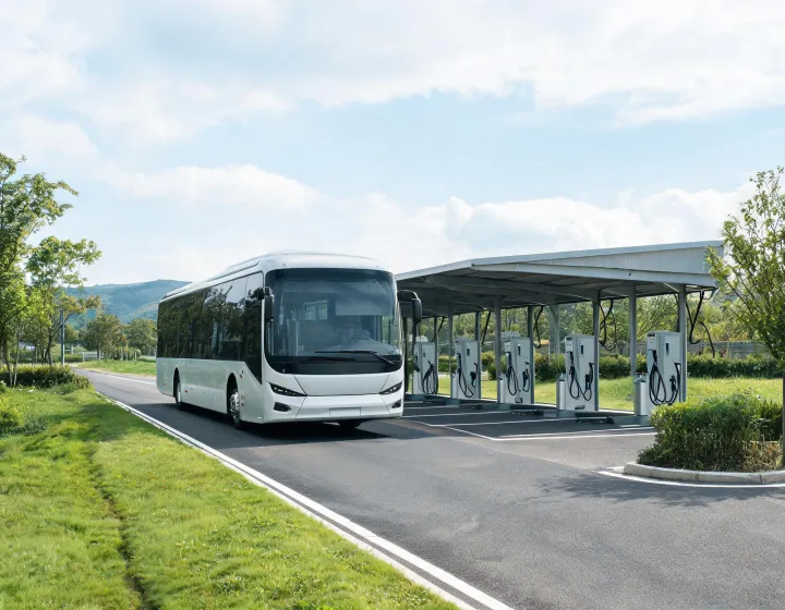 Unbranded electric coach on an intercity route with charging depot